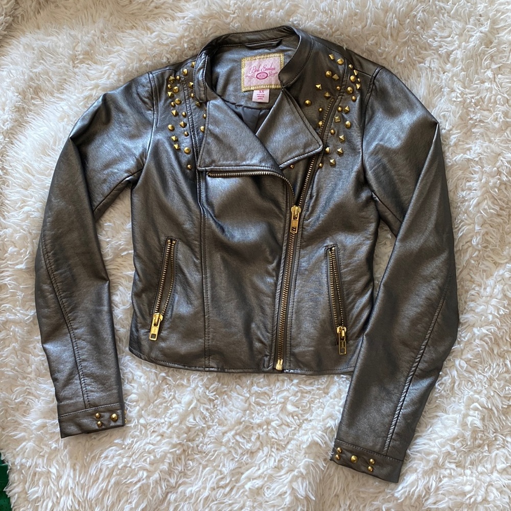 Metallic leather, gold studded zip up jacket. Gold detail in zippers.